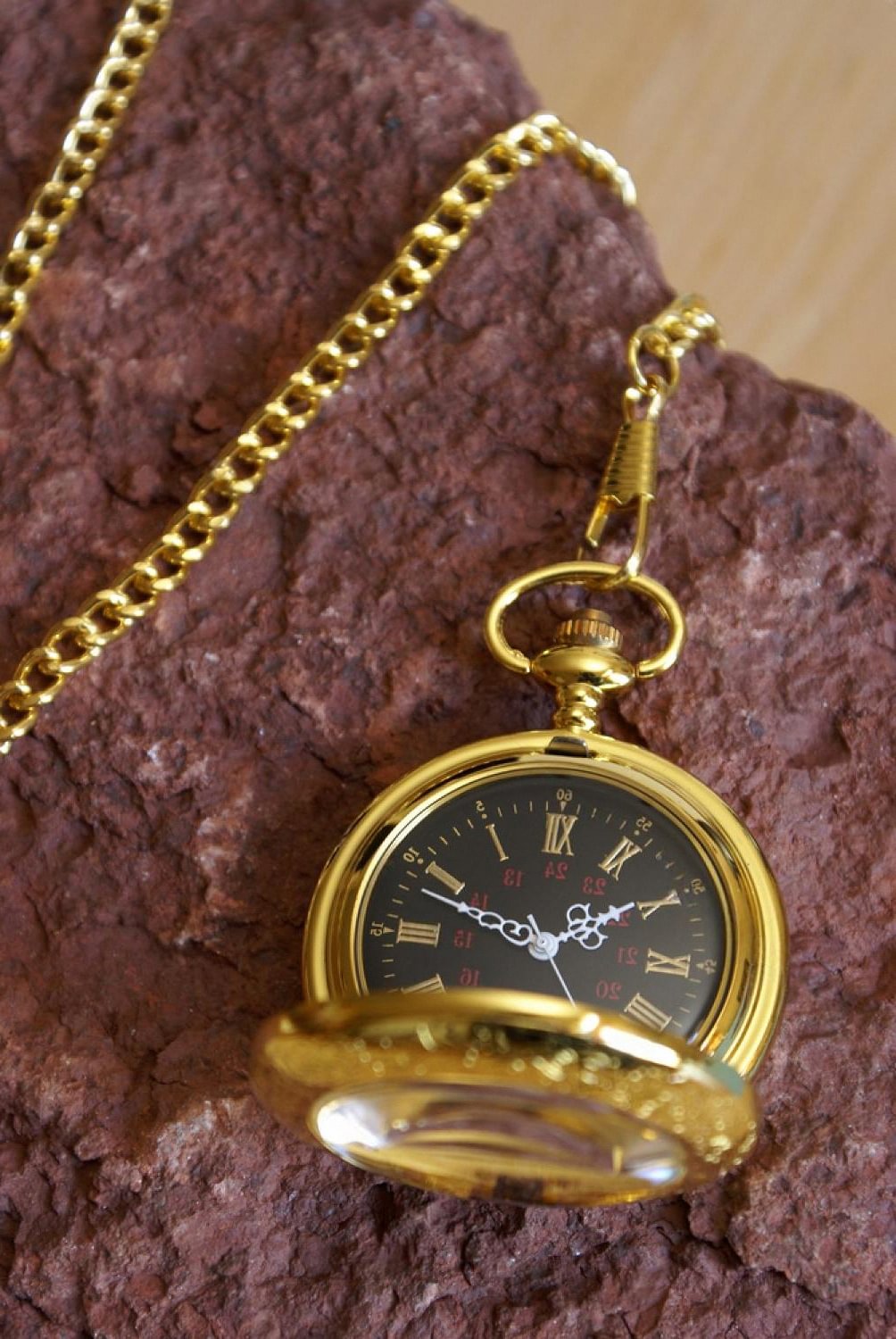 Gold luxury pocket-style timepiece resting on stone, symbolising heirloom collecting in the UAE